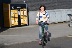 SEStran Project Officer Beth Harley-Jepson using a Brompton bike in front of the new locker